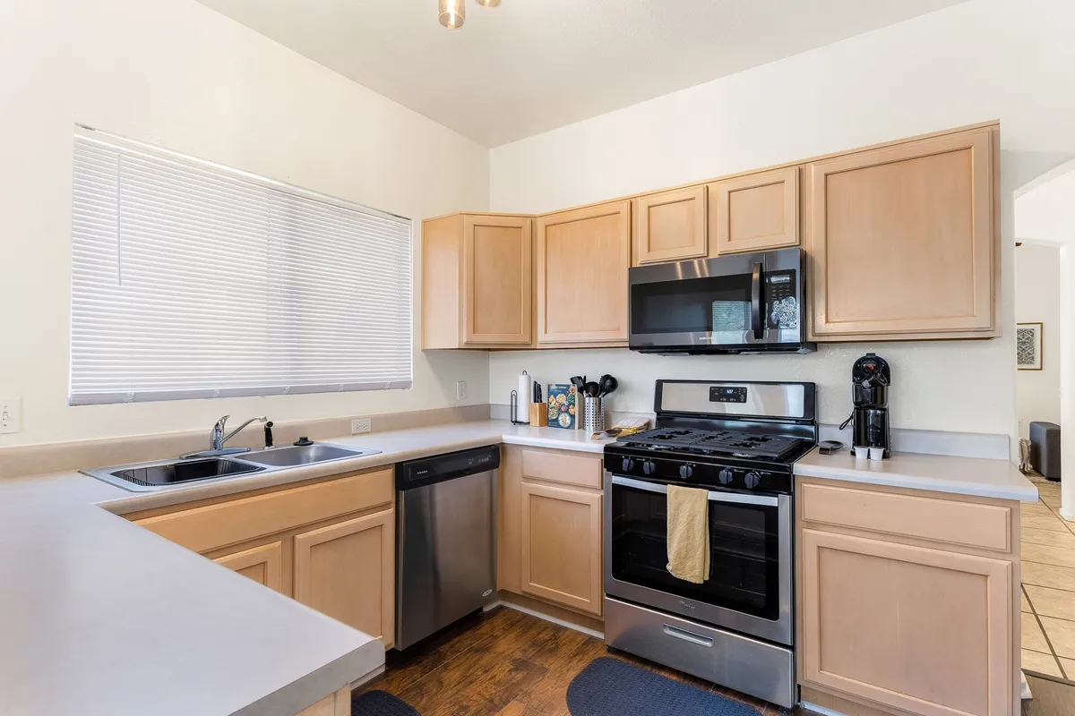 A modern, well-equipped kitchen with stainless steel appliances, ample countertop space, and a central sink. The area is perfect for cooking, baking, and hosting, reflecting a lively and functional heart of the home.